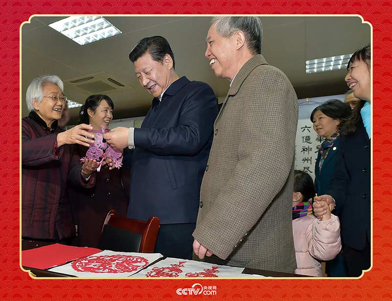 2015年2月15日，習(xí)近平在西安市雁塔區(qū)電子城街道二〇五所社區(qū)服務(wù)中心欣賞社區(qū)居民的剪紙作品。